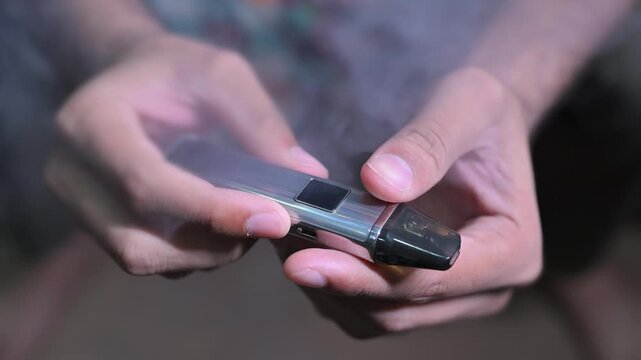 Hand holding an e-cigarette