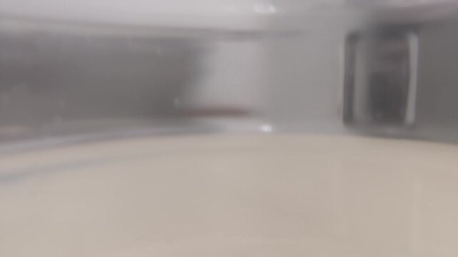 Indoor scene of a clean, empty, well-lit storage unit with shelves in the background, suitable for moving or storing items