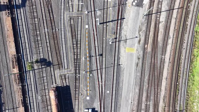 Aerial top down view of freight train moving along railway tracks