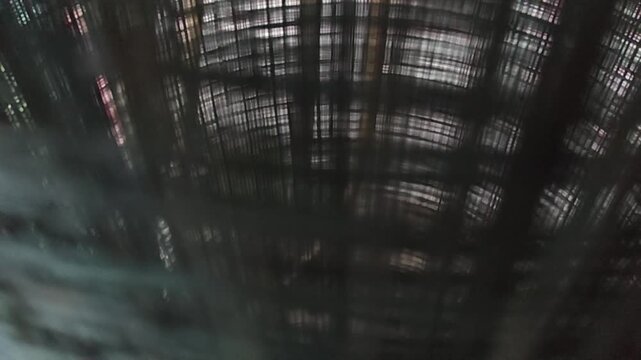 Dark abstract metallic wire grid mesh texture with geometric perspective pattern background for industrial design concept