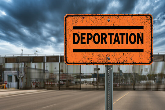 Sign indicating deportation at a border crossing in an urban area