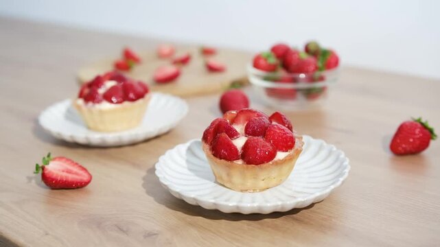 Strawberry tarts are placed on a wooden table