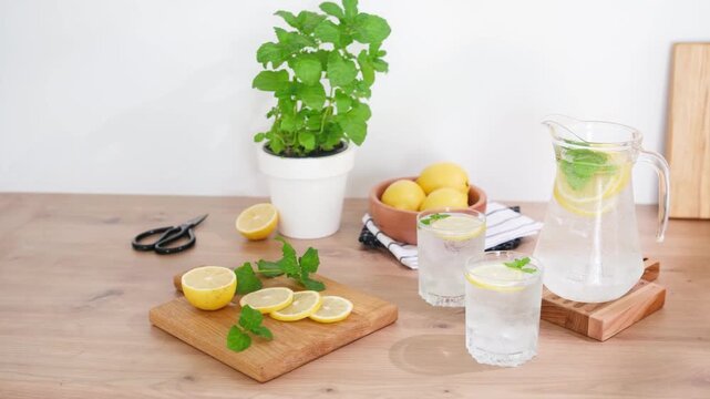 Fresh lemons and mint are prepared for making lemonade