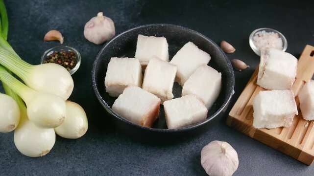 Chopped pork fat with onions and garlic on dark background