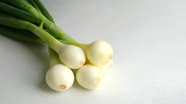 Fresh spring onions on a light white background