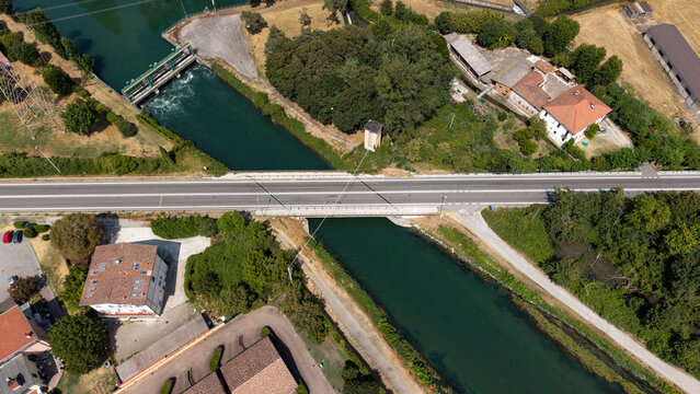 Overhead View of Canal and Bridge: An aerial perspective showcases a modern bridge spanning over a tranquil canal, Tavazzano con Villavesco, Lodi, Italy