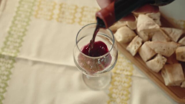 Female sommelier tasting red wine in winery, professional wine evaluation.