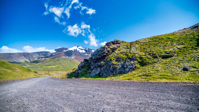 Driving along the road in Iceland approaching a volcanic area with dramatic scenery