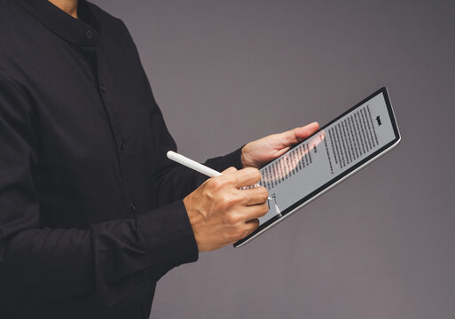 Person reviewing digital contract on tablet with stylus