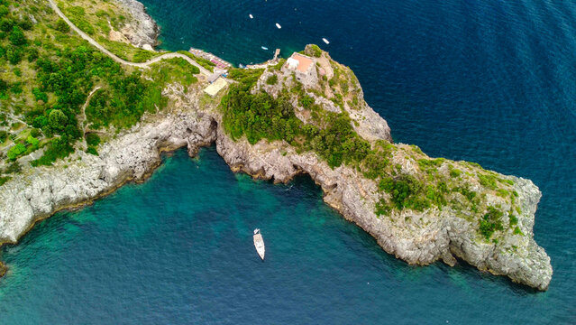 Cinematic drone view of Amalfi Coast road hugging