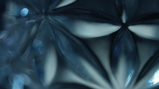 Macro view of blue cut crystal forming a floral pattern with bright reflections. Concept luxury, design, branding, wallpaper, advertising, art, and background use.