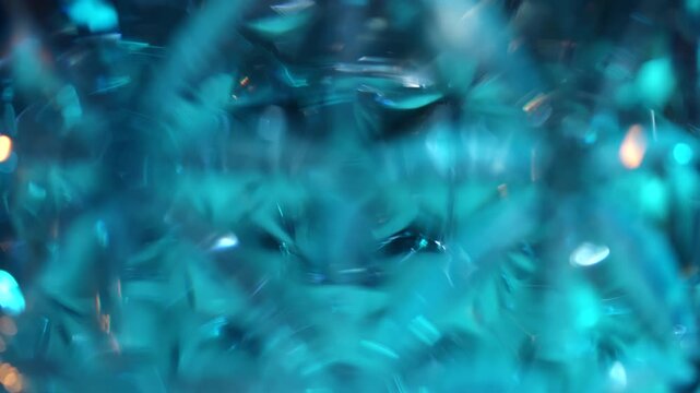Blurred defocused colored reflections from crystal glass create luminous bokeh on a dark background. Concept design, branding, luxury, wallpaper, advertising, and abstract visual use.