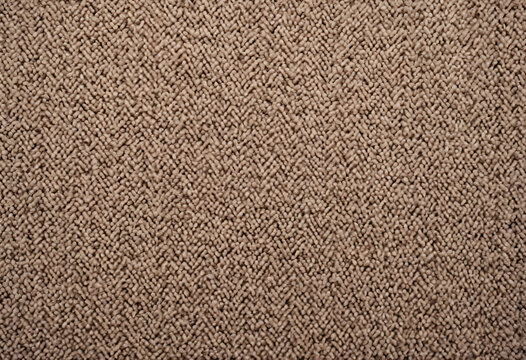 close-up of beige textured carpet with herringbone pattern