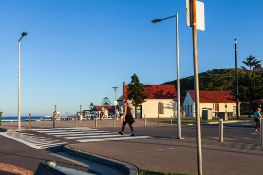 Motion blur of people walking along walkway at Nobbys head Newcastle