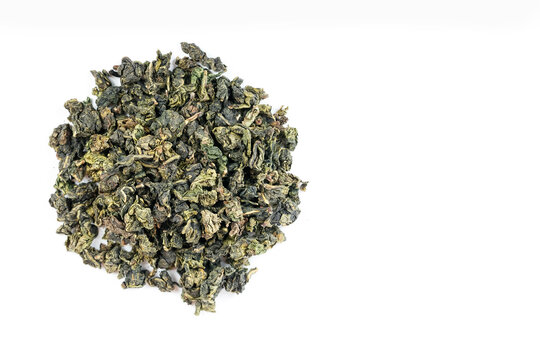 Dried tea leaves on white background, studio macro