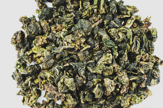 Dried tea leaves on white background, studio macro