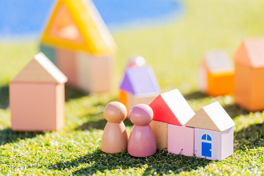 Couple with home concept depicted in childs toy blocks on fake grass