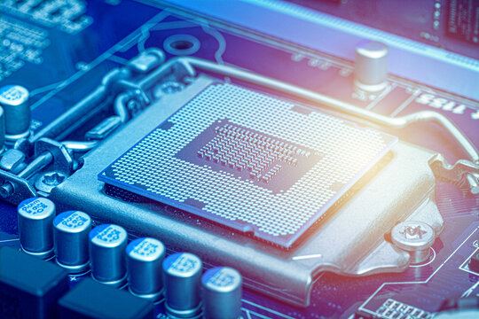 Computer processor chip mounted on a motherboard with electronic components in close up view. Technology background representing computing, hardware, performance, and digital innovation.