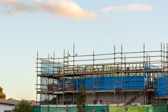 multi storey commercial worksite with scaffolding rising up around building under construction
