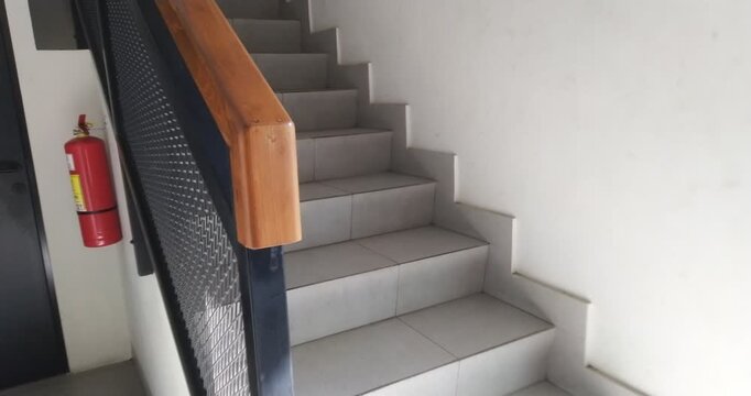 Modern Staircase with Metal Railing and Wooden Handrail.