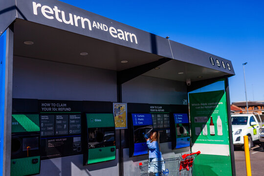 kid returning plastic bottle for recycling at return and earn collection point in Australia
