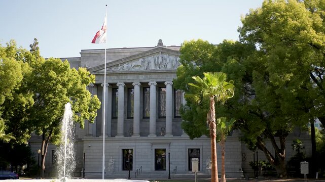 The California Courts of Appeal Third Appellate District building in Sacramento with trees and fountains present.