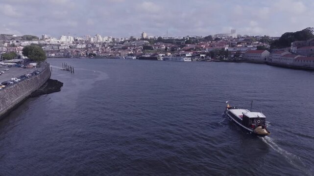 Aerial views of river Douro and a river boat with a load of passengers on it. Porto, Portugal