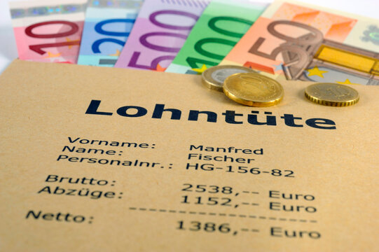 Eine Lohnt&uuml;te mit vielen Euro Banknoten und mit der Berechnung von Brutto und Netto