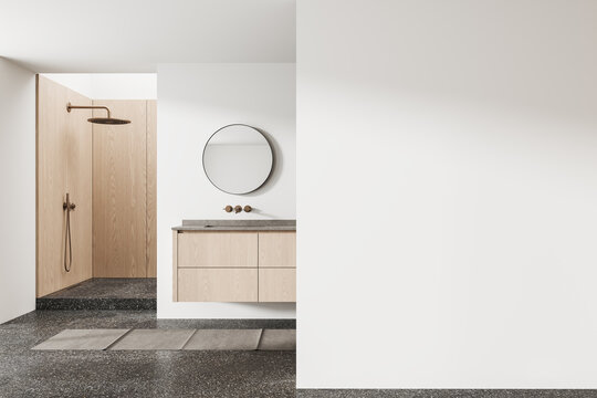 Minimal interior bathroom mockup with clean empty wall space, modern wooden shower area, floating vanity and round mirror creating serene contemporary display setting. 3D Rendering