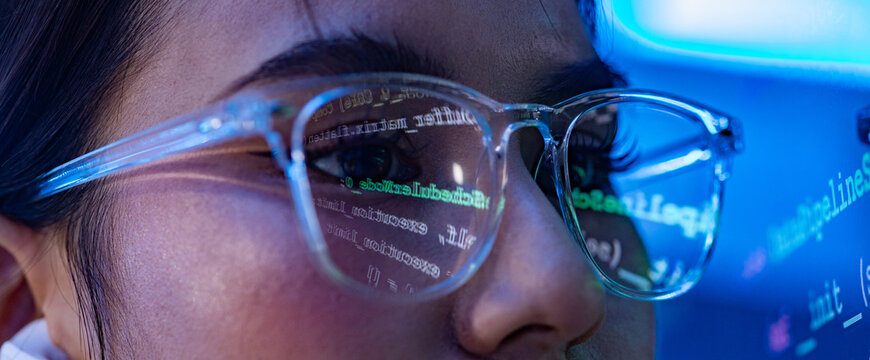 Woman glasses code reflection technology face eye screen blue programmer woman wearing clear glasses with code reflection on lens, close up face lit by blue screen glow during focused software work