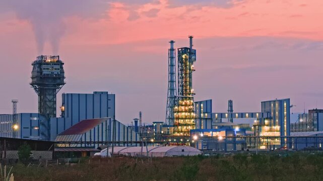 Modern Industrial Chemical Plant at Sunset with Illuminated Refinery Towers and Factory Infrastructure. Modern Industrial Plant at Sunset with Illuminated Factory Infrastructure. Industrial Manufactur