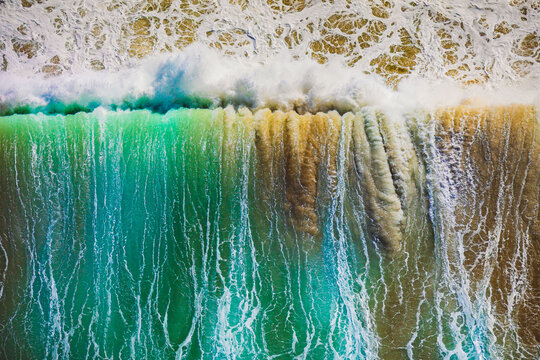 Chaotic surf churning up the sand at Wanda Beach