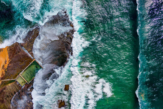 An abstract overhead of the waves crashing onto the rock platform at Mona Vale rock pool