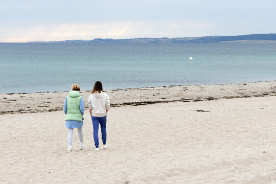 mother and daughter on Baltic Sea beach walk, motherhood, mother daughter relationship