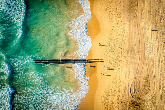 Manly Beach pipes extending from the shore into the turquoise water