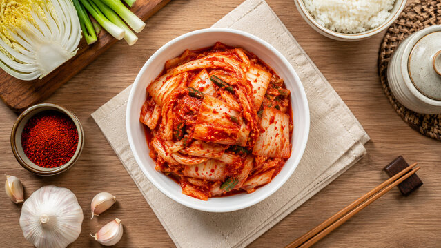 Top View of Traditional Korean Kimchi in White Bowl with Fresh Ingredients