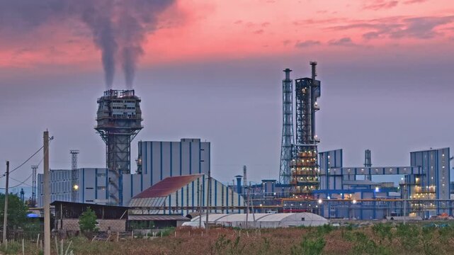 Modern Industrial Chemical Plant at Sunset with Illuminated Refinery Towers and Factory Infrastructure. Modern Industrial Plant at Sunset with Illuminated Factory Infrastructure. Industrial Manufactur