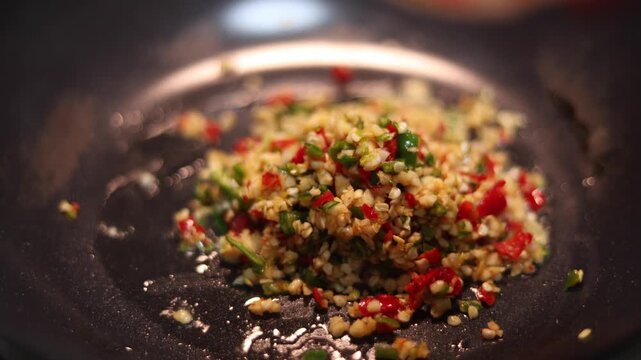 Stir-fry the chili and garlic in a pan