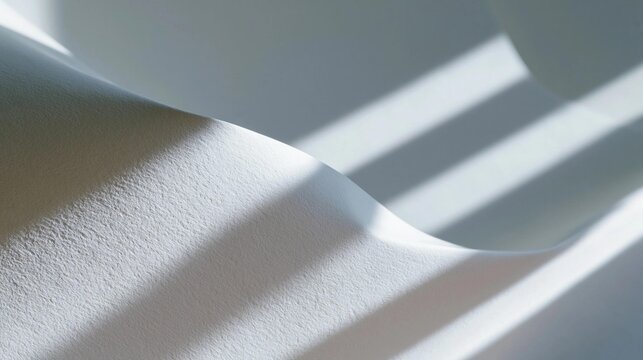 Close-up of a white fabric with a curved shape. the fabric appears to be made of a soft, silky material and has a smooth texture.