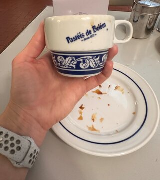 Pasteis de nata cafe featuring Past&eacute;is de Bel&eacute;m coffee cup after Portuguese pastry tasting, 2 April 2026, Lisbon, Portugal