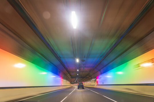 Colourful lighting and speed blur in an underground road tunnel
