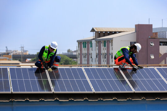 solar energy renewable sustainability.Engineers installing rooftop solar panels to support renewable energy, Net Zero and ESG goals with clean power, energy efficiency and sustainable infrastructure.