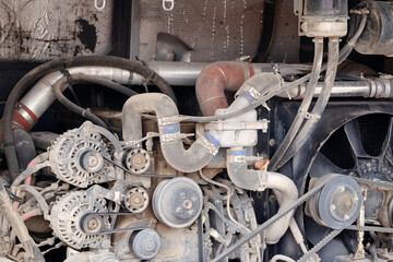 Fototapeta premium Open rear engine bay of a commercial passenger bus showing dual alternators, drive belts, fuel filter, and cooling system components.