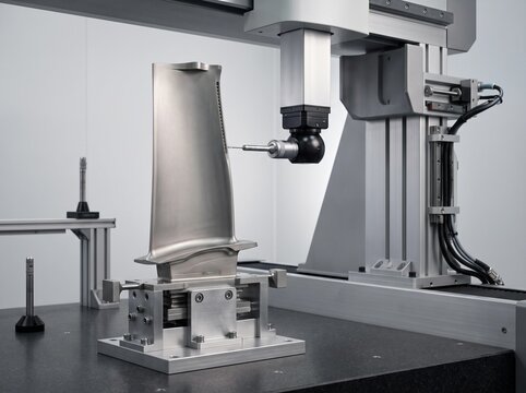 Coordinate measuring machine inspecting precision turbine blade for aerospace quality control