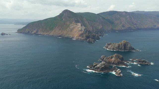 Aerial view flyover above rocks piercing through the Atlantic coast on the Coast of Galicia at Gabo Ortegal