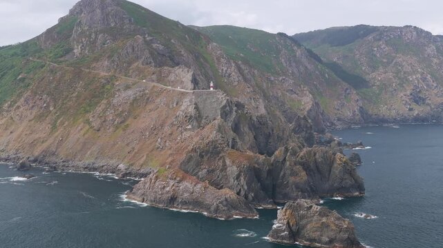 Aerial view flyover above rocks piercing through the Atlantic coast on the Coast of Galicia at Gabo Ortegal