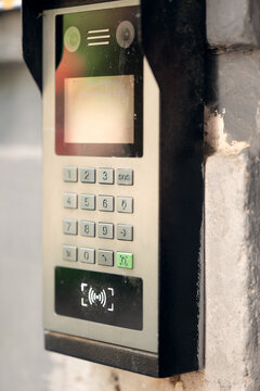 Modern outdoor smart intercom access panel with video camera, PIN keypad, and RFID contactless reader mounted at building entrance.