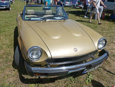 Garching near Munich, Germany - Old Timers Show: vintage 1980 golden Fiat 124 spider of 1980 frontal view