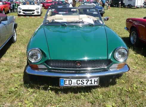 Garching near Munich, Germany - Old Timers Show: vintage green Fiat 124 spider BS1 sport car frontal view