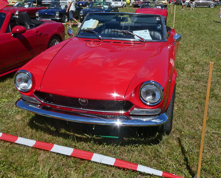 Garching near Munich, Germany - Old Timers Show: vintage red Fiat 124 spider BS1 sport car frontal view